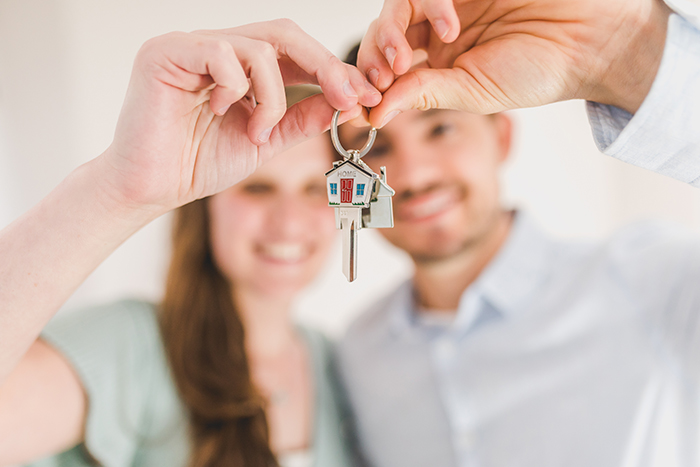 A couple holding keys to a new home